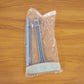 Close-up of the dual-sided brush head on the window mesh cleaning tool.