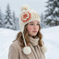 Children's winter cap with ear coverage and playful pom-pom