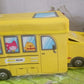 The School Bus Toy Storage Box folded flat, highlighting its space-saving and portable design.