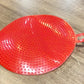 Close-up image of red silicone dish scrubbing sponge showing fine bristles