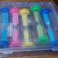The complete set of five plastic sand timers displayed in their original retail packaging.