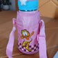 Thermos kids water bottle with cover and strap placed on table