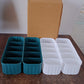 Display of 5-compartment drawer organizers in assorted vibrant colors.
