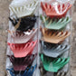 Vertical display of matte plastic hair clamp showing compact size