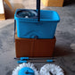 Detailed view of the sturdy plastic bucket and metal handle of the spin mop.