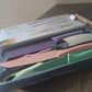 Detailed view of the high carbon steel blades and ergonomic colourful handles of the knife set.