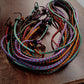 Single multicolor elastic luggage strap displayed clearly on a neutral background.