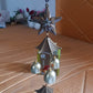 Decorative dragonfly wind chime hanging from porch beam, perfect for outdoor garden spaces