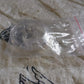 Silicone magnetic nose clip resting on surface before use
