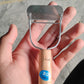 Side view of ergonomic wooden vegetable peeler used in cooking
