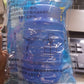 Portable water dispenser being used outdoors, ideal for camping or picnics.