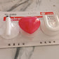 Multi-purpose adhesive hooks mounted on tile and glass surfaces