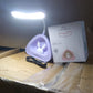 Compact LED desk light with button control on a clean workspace.