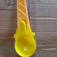 Plastic ice cream & watermelon scooper placed in kitchen environment