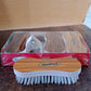 Detailed view of cleaning brush bristles with ergonomic grip for effective stain removal