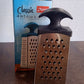 Close-up of stainless steel blades on 4-in-1 kitchen grater and slicer