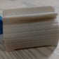 Toothpaste tube squeezer with its seat holder, emphasizing convenience and organization.