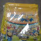 Assortment of party favor bags in various bright designs, featuring the drawstring style.