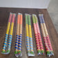 Vertical display of decorative dandiya sticks pair for festival dance use