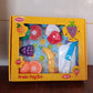 All seven pieces of the Aditi sliceable fruit cutting toy set neatly arranged.