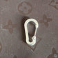 Close-up view of small snap hook clasp showing spring clip