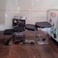 Four air tight plastic containers with included spoons and white lids for kitchen storage
