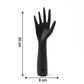Black hand jewelry display stand placed on shelf for accessories