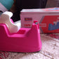 Tape dispenser with a roll of brown packaging tape, ready for shipping.