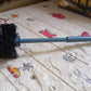 Plastic toilet cleaning brush with a strong handle for tough stains.