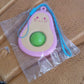 Portable avocado-shaped fidget toy with push bubble and strap