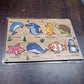 Overhead shot of the educational wooden puzzle with all sea animal pieces in place.