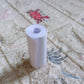 An overhead view of the thermal printer paper roll and a mini printer on a workspace.