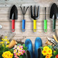 A collection of individual gardening hand tools, including a weeder and trowel, against a natural background.
