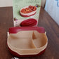 Compact airtight tiffin box with spoon, ideal for travel.