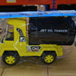 Close-up of the toy truck's wheels and chassis, emphasizing its heavy-duty construction.
