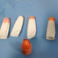 A collection of colorful finger covers, likely used as protectors with cutting tools.