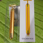 Vibrating facial massage tool in gold finish for skin rejuvenation.