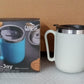 The Ganesh brand logo prominently displayed on the premium stainless steel coffee mug.