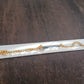 Elegant golden bracelet, ready for personalization.