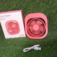 Compact USB fan in a travel scenario, fitting neatly into a small space.