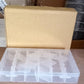 Empty clear plastic organizer box with adjustable dividers for various items.