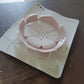 The white plastic soap dish displayed on a simple background.