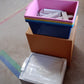 An empty plastic drawer storage unit on a white background, showcasing its clean design.