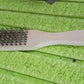 A close-up of the sturdy wooden handle and steel bristles connection.