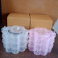 Close-up of transparent flower-shaped 3-layer storage box from India
