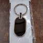 Dual tone black and silver oval keychain accessory for keys and bags