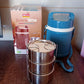 An insulated stainless steel dabba on a table, ready for a healthy meal.