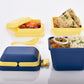 Blue 3-compartment airtight lunch box with ergonomic handle & secure push lock.