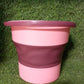 The compact foldable water bucket neatly collapsed for easy storage.