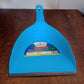 Angled view of the grey plastic dustpan, ready for daily cleaning tasks.